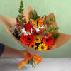 The Bright Beauty Butterfly Wrapped Bouquet is a beautiful assortment of warm