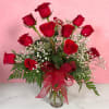 The Classic rendition of One Dozen Red Roses Vased by Savilles Florist