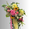 Large bouquet with pink roses, sunflowers, and yellow chrysanthemums tied with a pink ribbon