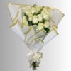 Bouquet of cream roses wrapped in white paper with gold trim and a ribbon