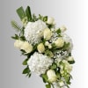 White roses and hydrangeas arranged with greenery in a bouquet