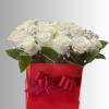 White roses in a red gift box with a ribbon bow