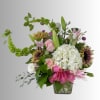 Mixed bouquet in a clear glass vase with pink lilies, roses, and white hydrangea