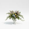 Mixed pastel bouquet in a white pedestal vase