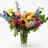 Colorful mixed flower arrangement in a clear glass vase
