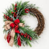 Holiday wreath with pine, red berries, and a red-and-tan bow