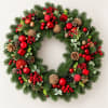 Christmas wreath with pine, red ornaments, berries, and pinecones