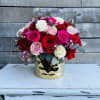 Bouquet of red, pink, and white roses in a gold vase