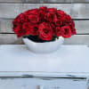 Red roses arranged in a silver bowl vase
