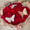 Bouquet of red roses with decorative butterfly accents