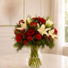 Red roses and white lilies arranged in a clear glass vase