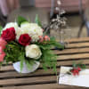 Exquisite design made up of red tipped Sweetness roses, cedar, pine, coffee