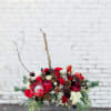 Stunning mix of holiday greens and blooms, all designed in a ceramic