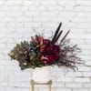 This striking arrangement has moody tones of deep burgundy dahlias (when in