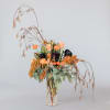 This stunning holiday arrangement is made up of holiday black roses, whites