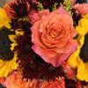 Close-up bouquet with a peach rose and yellow sunflowers