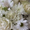 White bouquet with roses, daisies, and ruffled blooms