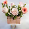 An arrangement of roses, white aster monte casino, and mini gerbera daisy