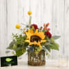 Sunflower arrangement in a glass vase with a wicker base