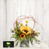 Sunflower arrangement in a metal container with berries and twig accents