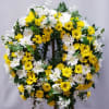 Yellow and white daisy wreath on a standing easel