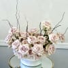 A soft and elegant arrangement of blush roses styled in a modern