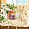 A reverent presentation piece centered on a religious icon, this rectangular floral