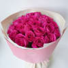 Bouquet of bright pink roses wrapped in pink paper