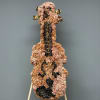 Floral arrangement shaped like a guitar on a stand
