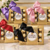 Ferrero Rocher chocolate gift boxes with satin bows in purple, pink, red, and black