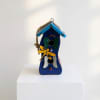 Blue wooden birdhouse with painted butterfly decorations