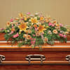 Large floral spray on a wooden casket