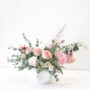 Pink and white floral arrangement in a white vase