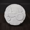 Round white decorative plaque with a raised tractor design