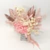 Pink and cream dried floral arrangement in a gray vase