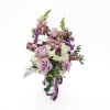 Lavender Whisper is an elegant front-facing floral arrangement designed in a clear