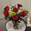Red roses and white alstroemeria in a clear glass vase