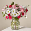 Pink roses and white daisies in a clear glass vase