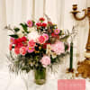 Mixed pink and white flower arrangement in a glass vase