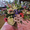 Mixed bouquet with pink, purple, white, and blue flowers in a vase