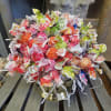 Bouquet of colorful wrapped candies in a gold vase