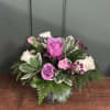 A graceful blend of lavender and white roses accented with soft pink