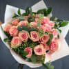 Bouquet of pink roses wrapped in white paper