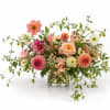 Mixed pink and peach flowers in a clear glass vase