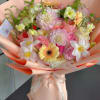 A lush, garden-inspired bouquet featuring a beautiful seasonal selection of garden roses