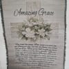 Framed wall hanging with white flowers and the words Amazing Grace