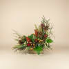 Rustic arrangement with pinecones, berries, and greenery in a wooden box
