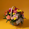 Mixed flower basket with roses, carnations, and yellow mums