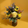 Yellow and brown mixed bouquet in a glass vase