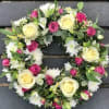 Floral wreath with cream and pink roses and white daisies